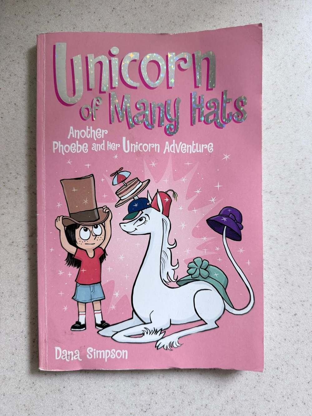 Unicorn of Many Hats (Phoebe and Her Unicorn Series #7) by Dana Simpson